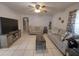 Spacious living room with tile floors, modern sofas, a ceiling fan, and entertainment center at 108 Prospect Ave, Winter Haven, FL 33880