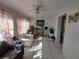 Bright living room featuring tile flooring, a decorative ceiling fan and natural light at 108 Prospect Ave, Winter Haven, FL 33880