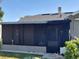 Enclosed, screened-in outdoor living space ideal for relaxation and enjoying the outdoors in comfort at 108 Prospect Ave, Winter Haven, FL 33880
