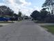 Quiet residential street view with well-maintained homes, mature trees, and clear blue skies at 108 Prospect Ave, Winter Haven, FL 33880