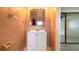 Bathroom features vanity, tile flooring, large mirror, and neutral walls at 110 Lake Mattie Rd, Auburndale, FL 33823