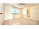 Bright bedroom features neutral walls, tile flooring, ceiling fan, and a window with natural light at 110 Lake Mattie Rd, Auburndale, FL 33823