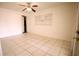 Bright living room with tile flooring, ceiling fan, and built-in shelving unit at 110 Lake Mattie Rd, Auburndale, FL 33823