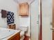 Bathroom with a shower, wood cabinet and decorative elements at 1107 Saint Anne Shrine Rd, Lake Wales, FL 33898