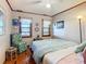 Cozy bedroom with a ceiling fan and wood floors at 1107 Saint Anne Shrine Rd, Lake Wales, FL 33898