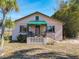 Charming home with a landscaped yard, inviting entry, and covered awning at 1107 Saint Anne Shrine Rd, Lake Wales, FL 33898