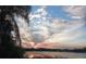 Scenic lake view capturing the beauty of sunset, enhancing the property's natural appeal and tranquility at 1107 Saint Anne Shrine Rd, Lake Wales, FL 33898