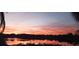 Beautiful sunset reflecting on calm lake waters at 1107 Saint Anne Shrine Rd, Lake Wales, FL 33898