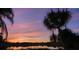 Stunning sunset over a serene lake with palm trees at 1107 Saint Anne Shrine Rd, Lake Wales, FL 33898
