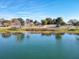 Scenic lake view showing neighborhood homes and blue skies at 1107 Saint Anne Shrine Rd, Lake Wales, FL 33898