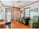 Living room with wood floors, ceiling fan, and natural light at 1107 Saint Anne Shrine Rd, Lake Wales, FL 33898