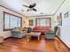 Cozy living room with hardwood floors, comfortable seating, and ceiling fan at 1107 Saint Anne Shrine Rd, Lake Wales, FL 33898
