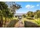 Beautiful backyard garden with a pergola and serene water view at 1121 Sunset Dr, Lake Wales, FL 33853