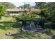 Expansive backyard with a pergola, lush lawn, and a cozy fire pit area at 1121 Sunset Dr, Lake Wales, FL 33853