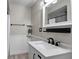 Bathroom with modern vanity, decorative mirror, and neutral tones at 1121 Sunset Dr, Lake Wales, FL 33853