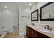 Bathroom features a dual sink vanity with marble countertop, and tile flooring at 1121 Sunset Dr, Lake Wales, FL 33853