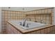 A tiled bathtub with tile surround and chrome fixtures at 1121 Sunset Dr, Lake Wales, FL 33853