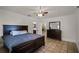 Bedroom with tile floors, a ceiling fan, and a dark wood bed and dresser at 1121 Sunset Dr, Lake Wales, FL 33853