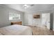 Bedroom with a tv on the wall, a dresser and a door to the ensuite bathroom at 1121 Sunset Dr, Lake Wales, FL 33853