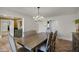 Inviting dining room features a stunning chandelier and neutral tones, perfect for gatherings and everyday dining at 1121 Sunset Dr, Lake Wales, FL 33853