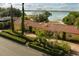Charming home featuring a red tile roof, well-manicured hedges and waterfront views at 1121 Sunset Dr, Lake Wales, FL 33853