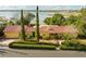 Lakefront home featuring a red tile roof and lush landscaping, offering serene views and curb appeal at 1121 Sunset Dr, Lake Wales, FL 33853
