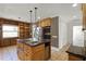 Functional kitchen island with sink, built-in appliances, and storage, complemented by checkered backsplash accents at 1121 Sunset Dr, Lake Wales, FL 33853