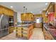 Spacious kitchen featuring custom wood cabinetry, stainless steel appliances, and a central island at 1121 Sunset Dr, Lake Wales, FL 33853