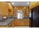 Kitchen with stainless steel appliances, granite countertops, a decorative backsplash, and custom wood cabinetry at 1121 Sunset Dr, Lake Wales, FL 33853