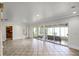 Expansive living area with access to a sunroom and kitchen, featuring tile flooring at 1121 Sunset Dr, Lake Wales, FL 33853