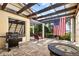 Inviting outdoor patio with grill, fire pit, stylish furniture, and an American flag at 1121 Sunset Dr, Lake Wales, FL 33853