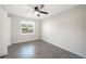 Well-lit bedroom with ceiling fan and tile flooring, access to backyard at 1139 Carefree Cove Dr, Winter Haven, FL 33881