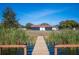 Wooden dock leads to a lakefront home with scenic views at 1139 Carefree Cove Dr, Winter Haven, FL 33881