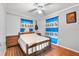 Bedroom with wooden bed frame and blue patterned curtains at 1330 Skyview Blvd, Lakeland, FL 33801