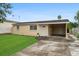 Ranch-style home with carport and well-maintained lawn at 1330 Skyview Blvd, Lakeland, FL 33801