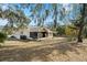 Spacious backyard with screened patio and lush landscaping at 1406 Chamberlain Loop, Lake Wales, FL 33853