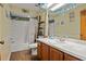 Bathroom with a shower/tub combo, wood vanity and tile floors at 1406 Chamberlain Loop, Lake Wales, FL 33853