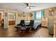Main bedroom with ensuite bathroom access and two armchairs at 1406 Chamberlain Loop, Lake Wales, FL 33853