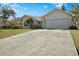 House exterior showcasing a large driveway and well-maintained lawn at 1406 Chamberlain Loop, Lake Wales, FL 33853