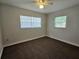 Bedroom with ceiling fan, carpet, and window at 1506 32Nd St Nw, Winter Haven, FL 33881