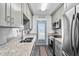 Modern kitchen with gray cabinets and stainless steel appliances at 1600 W Lake Parker Dr # C25, Lakeland, FL 33805