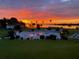 Community pool with lake view at sunset at 1600 W Lake Parker Dr # C25, Lakeland, FL 33805