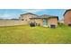 Grass backyard with grill and AC unit at 1713 Yellow Trl, Lakeland, FL 33801