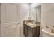 Clean bathroom with granite countertop, dark brown vanity, and a large mirror at 1713 Yellow Trl, Lakeland, FL 33801