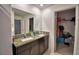 Double vanity bathroom with granite countertop and linen closet at 1713 Yellow Trl, Lakeland, FL 33801