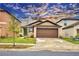 Beige house with brown garage door, green front door, and well-maintained lawn at 1713 Yellow Trl, Lakeland, FL 33801
