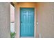 Teal front door with keyless entry and doorbell camera at 1713 Yellow Trl, Lakeland, FL 33801