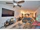 Living room with sectional sofa, large TV, and view of kitchen at 1713 Yellow Trl, Lakeland, FL 33801