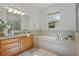 Relaxing bathroom featuring a garden tub and wood cabinets at 176 Brookshire Dr, Lake Wales, FL 33898