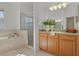 Bathroom with soaking tub, shower, and wood vanity at 176 Brookshire Dr, Lake Wales, FL 33898